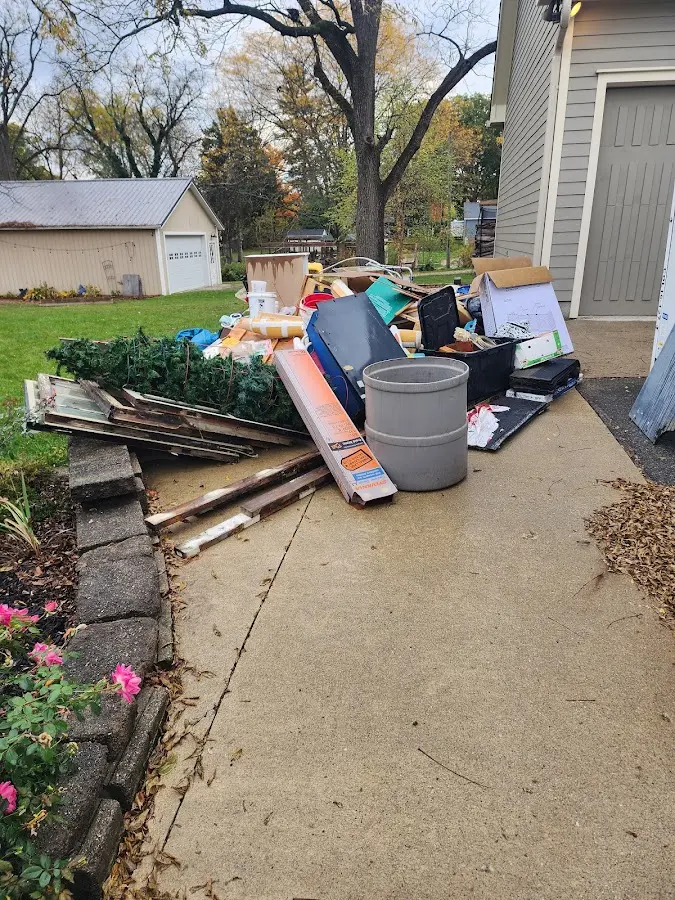 Dumpster being loaded with debris for Roofing Dumpster Rental in Henrietta